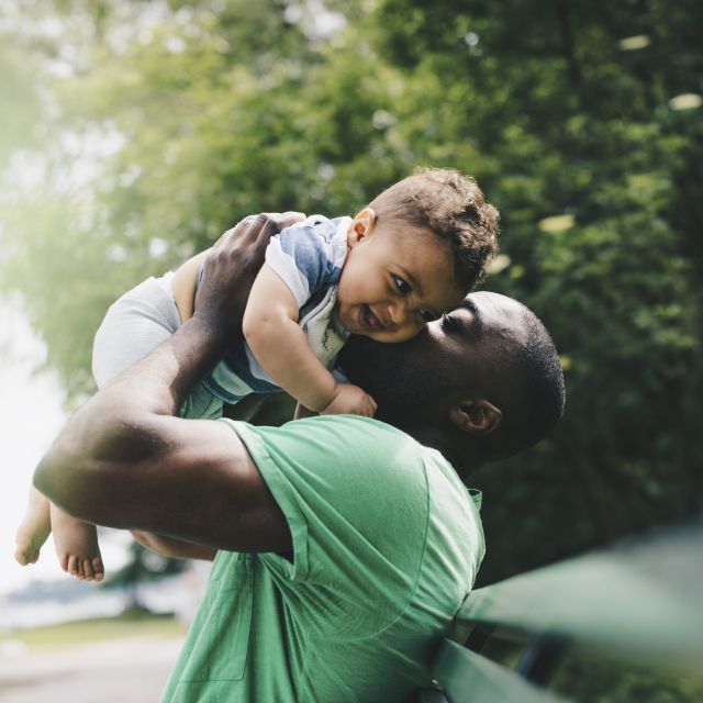 Man holding up baby
