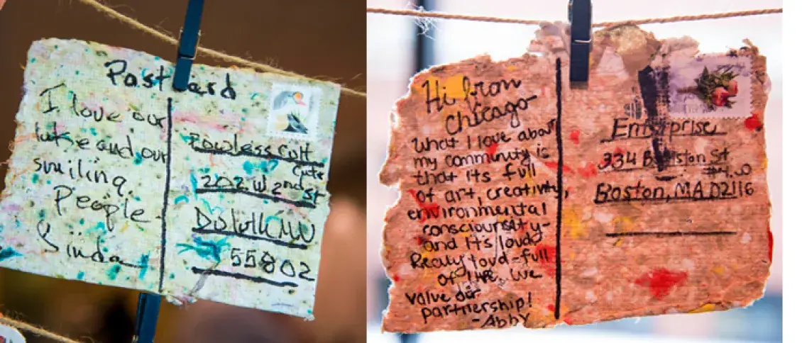 two postcards hanging on a clothesline