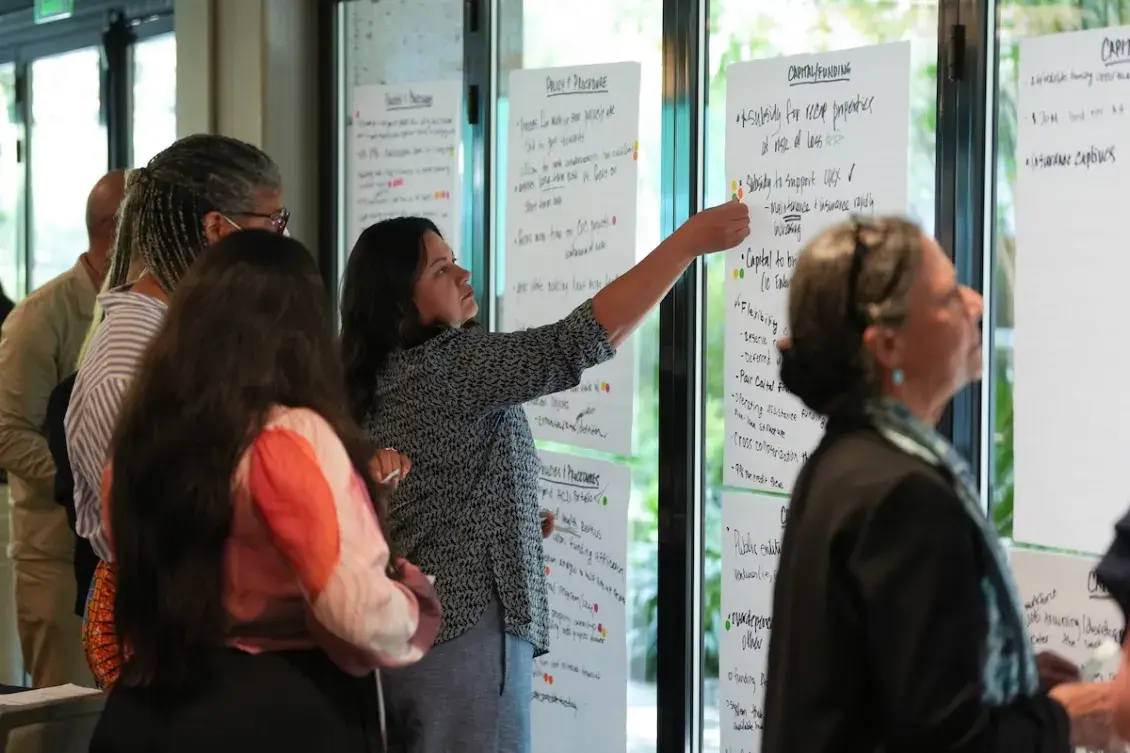 Woman placing sticker on poster paper