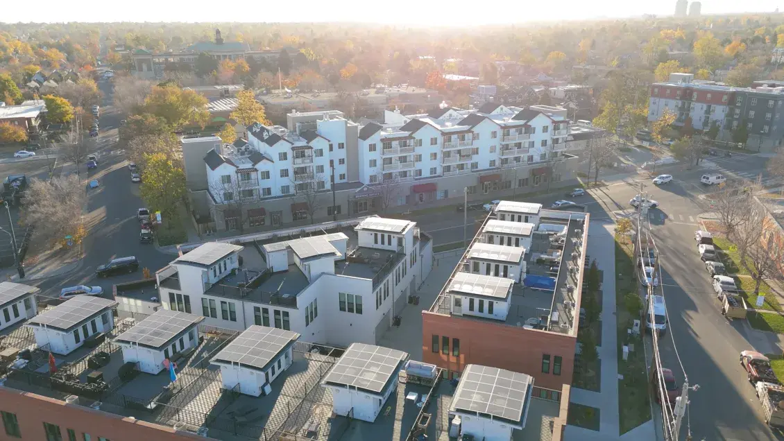 Sunlit aerial view of housing development 