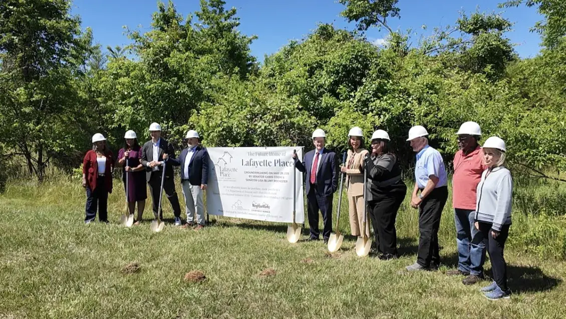 Picture with shovels standing around a Lafayette Project sign