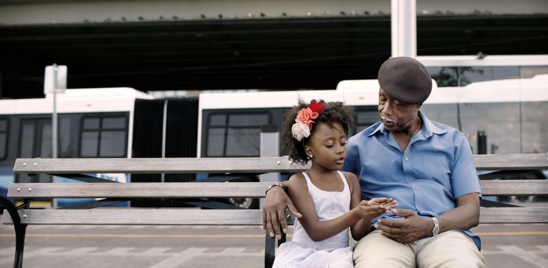 man and girl sitting on a bench talking