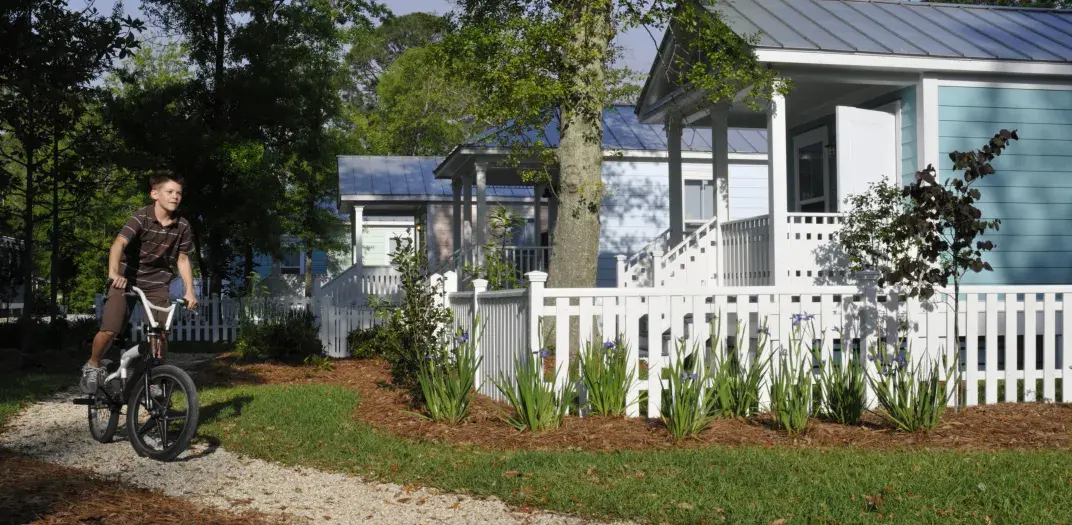 Boy rides his bike in Cottage Square, Lafitte, New Orleans