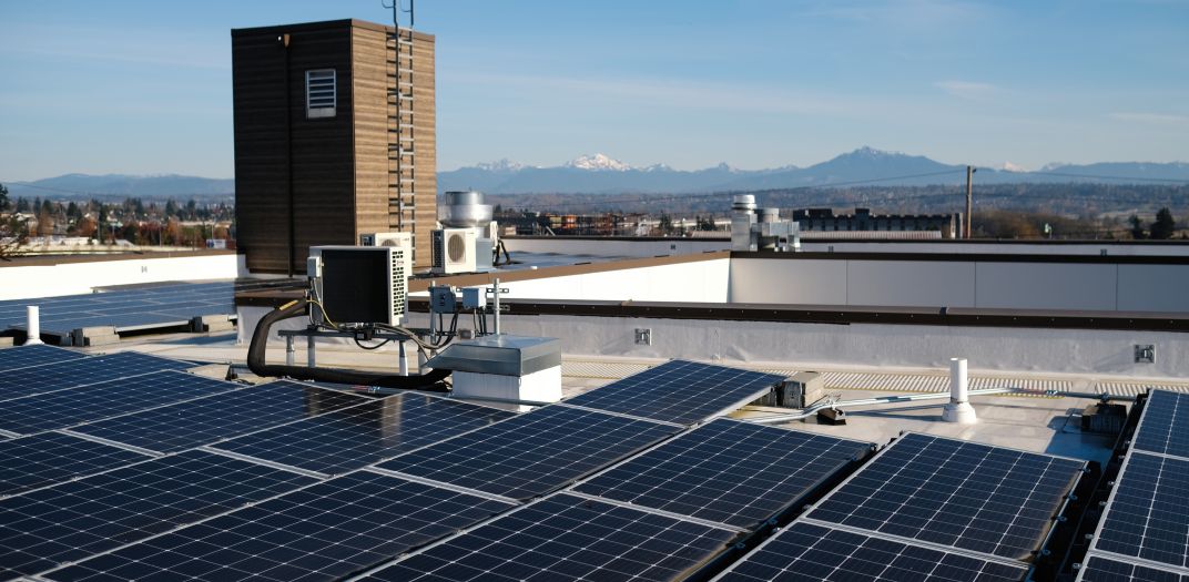 Solar panels installed on a rooftop of an apartment building