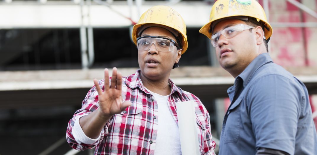 Two construction workers talking