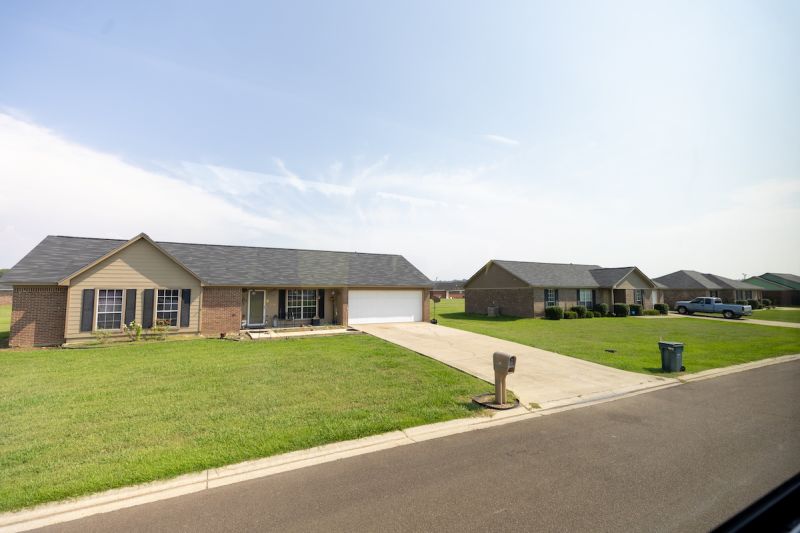 Single-family, red-brick homes surrounded by large green lawns