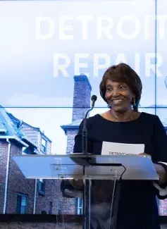 Woman standing behind podium