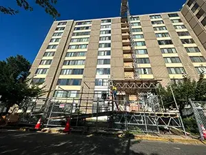 Skyward view of an apartment building with scaffolding in front