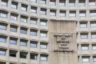 Grayish building with rows of windows with the word Department of Housing and Urban Development