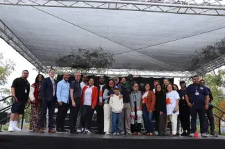 Group of smiling people standing on a stage
