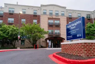 Exterior of red brick and tan building, Park Heights Place, senior housing in Baltimore