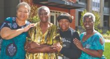 Four senior woman in front of a building