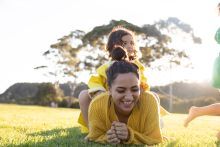 family playing in the grass