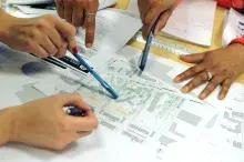 People writing on plans