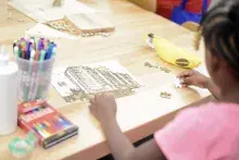 Girl making a puzzle of her apartment building