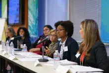 A group of woman speaking on a panel