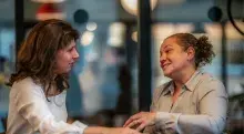 Two women sitting at a table talking