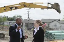 Partners outside construction talking