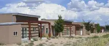 Wa-Di Housing development in Santo Domingo, New Mexico against a blue clouded sky