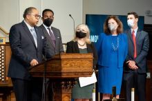 Picture of people standing around podium