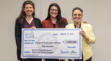 Picture of three women with oversized check