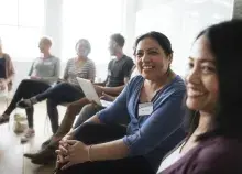 Seated woman smiling amid others