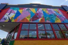 A community center in the Hilltop neighborhood with a colorful mural on the upper level of the building