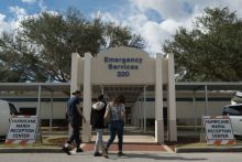 People entering emergency services location after hurricane