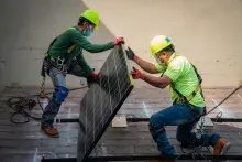 Men installing solar panels