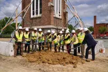 People with shovelings digging into dirt