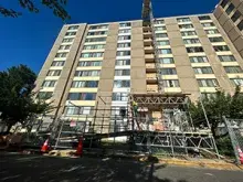 Skyward view of an apartment building with scaffolding in front