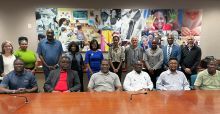 Members of the Enterprise Southeast FBDI Cohort seated at a conference table in front of a mural