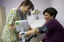 women getting her blood pressure checked