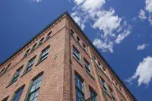 Brick building and blue sky with a few clouds