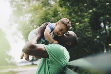 Man holding up baby