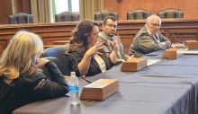 Group of People Seated at a Table Testifying