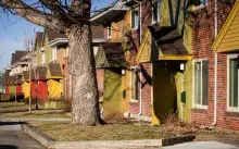 Red brick townhomes with colorful trimming