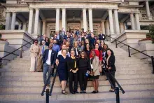 Group of people standing on the steps of a government building