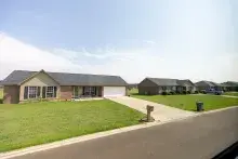 Single-family, red-brick homes surrounded by large green lawns