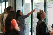 Woman placing sticker on poster paper