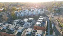 Sunlit aerial view of housing development 