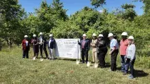 Picture with shovels standing around a Lafayette Project sign
