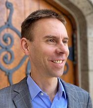 Mark Elsdon in front of a wooden door