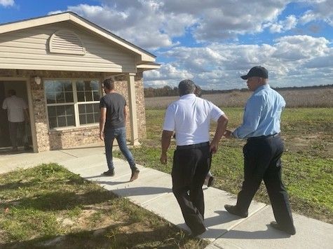 People touring rural housing LA