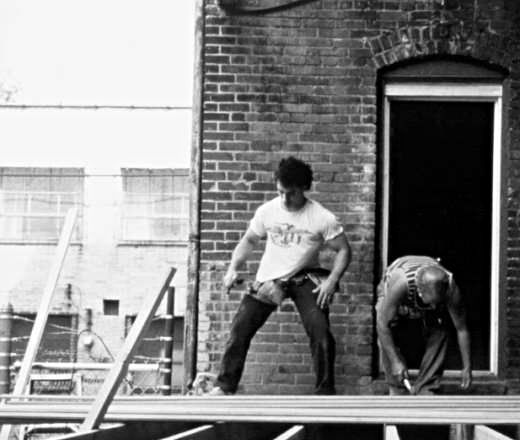 men building a deck on a building