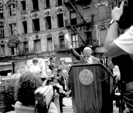 Jim Rouse at a podium in a press event in the city