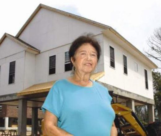 woman standing in front of a home being constructed