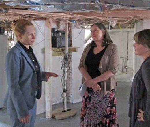Three women in discussion in building construction project
