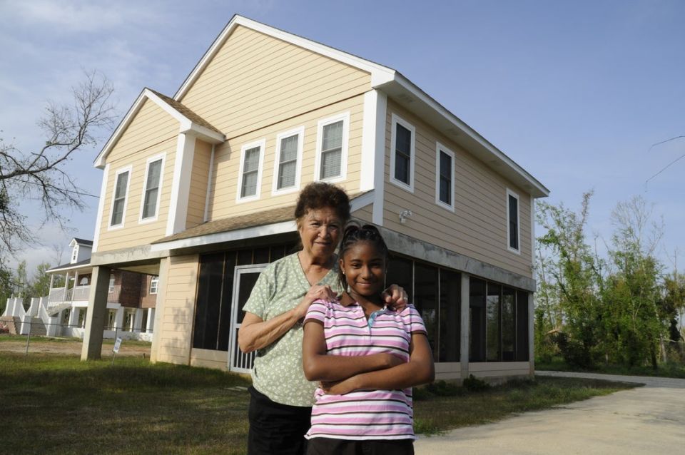 Woman and girl in front of a newly renovated Mississippi home