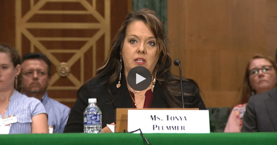 Tonya Plummer seated behind a microphone in a Senate hearing room